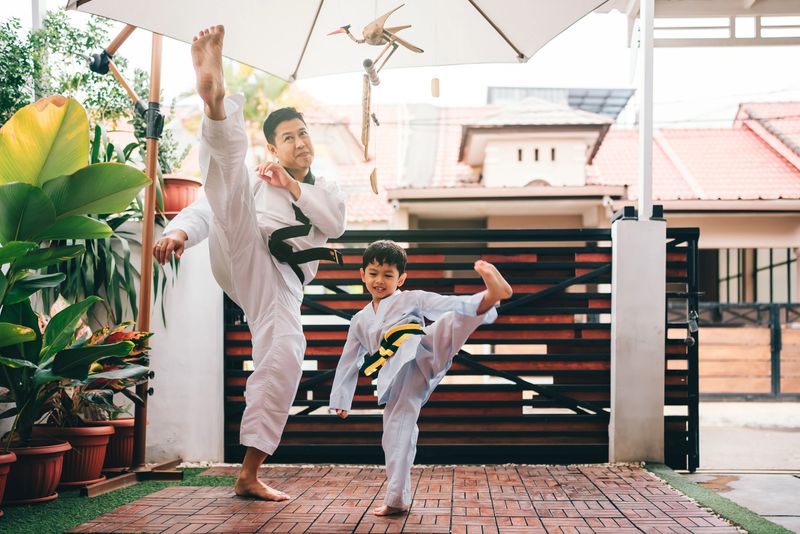 martial artist toddler working out with his father as trainer