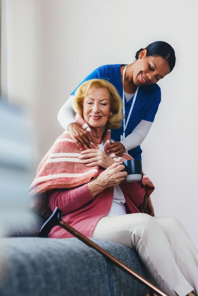 A caring caregiver provides comfort to an elderly woman, fostering warmth and companionship in a supportive environment. The scene radiates friendliness and empathy, depicting daily life and compassionate caregiving support.