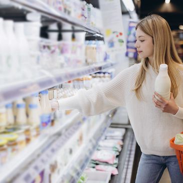 A customer choosing dairy products at a store