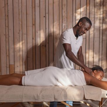 Man giving a woman a back massage.