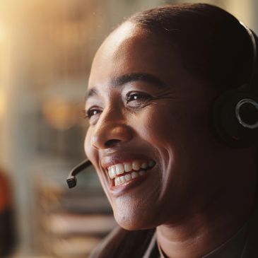 Smiling woman wearing headset at work.
