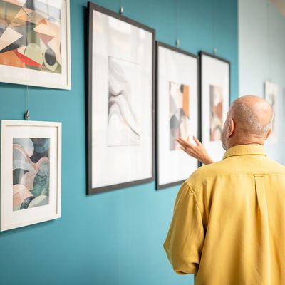Man looking at painting on wall