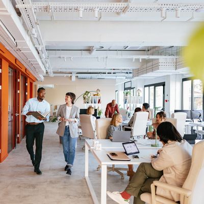 Colleagues collaborating and working in a modern open office space.