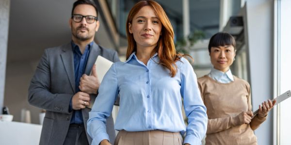 Confident business team posing together in an office setting.