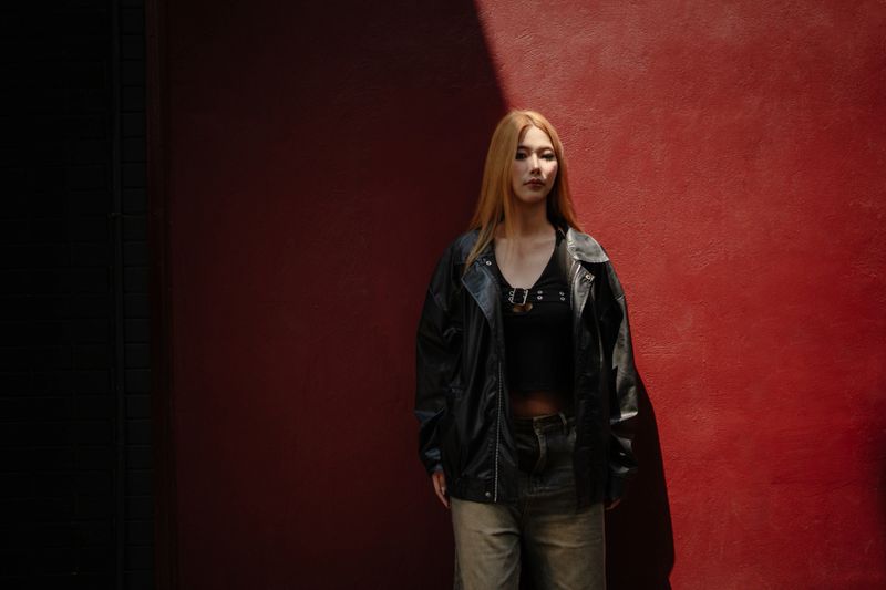 A stylish model showcasing the latest fashion trends in a vibrant cityscape.