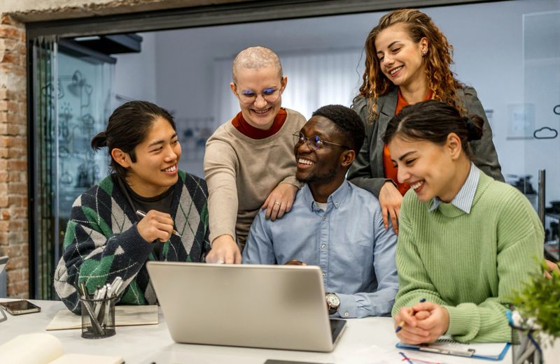 Group of young people discussing a new project in the office