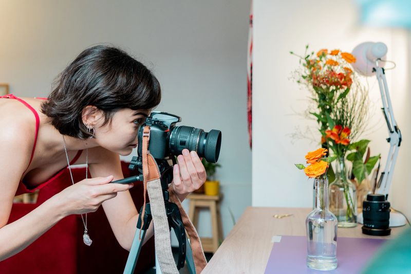 Photographer taking photos of a potted plant at home