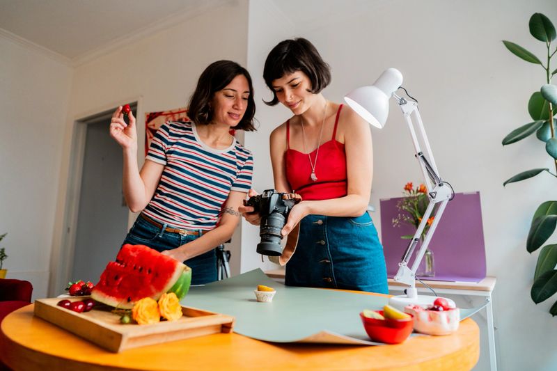 Photographer and assistant talking during photo shoot