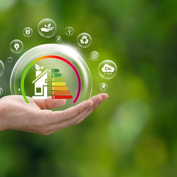 Hand holding an eco-friendly energy efficiency rating symbol with green background.