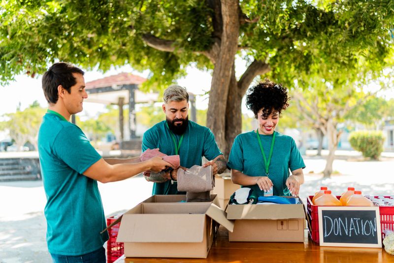 Volunteers talking and organizing donation boxes outdoors
