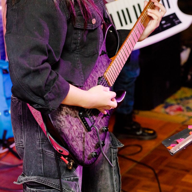 Thai teenager playing electric guitar