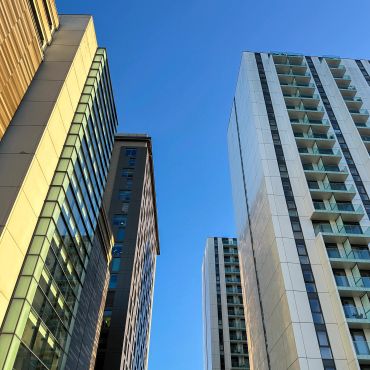 Modern skyscrapers against a clear blue sky.