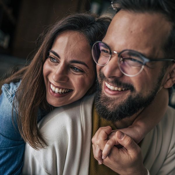 Happy couple affected by ADHD sharing a joyful moment embracing each other.