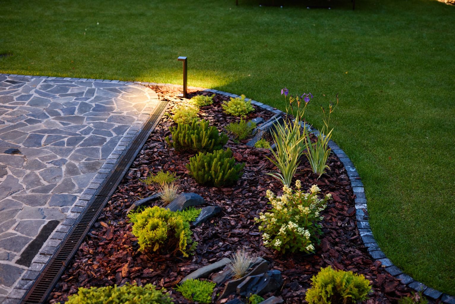 Mulched beds and planting areas that make the whole yard read cleaner.