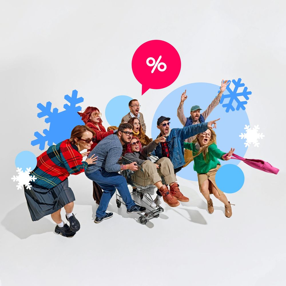 Group of people excitedly pushing a shopping cart with discount and snowflake icons.