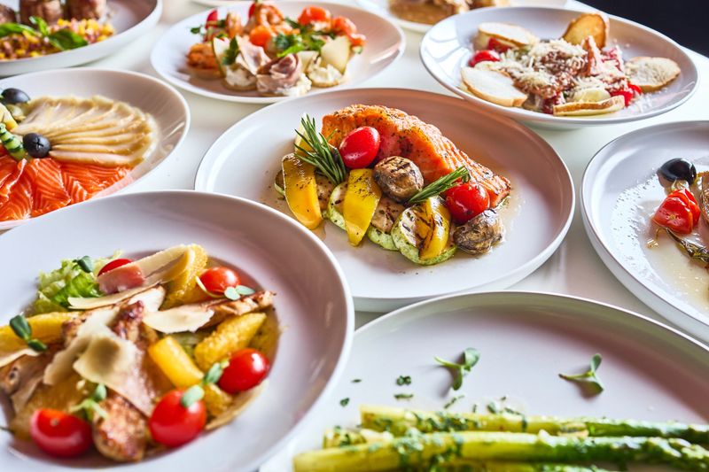 A table setting with a variety of gourmet dishes, offering a luxurious and unforgettable dining experience.