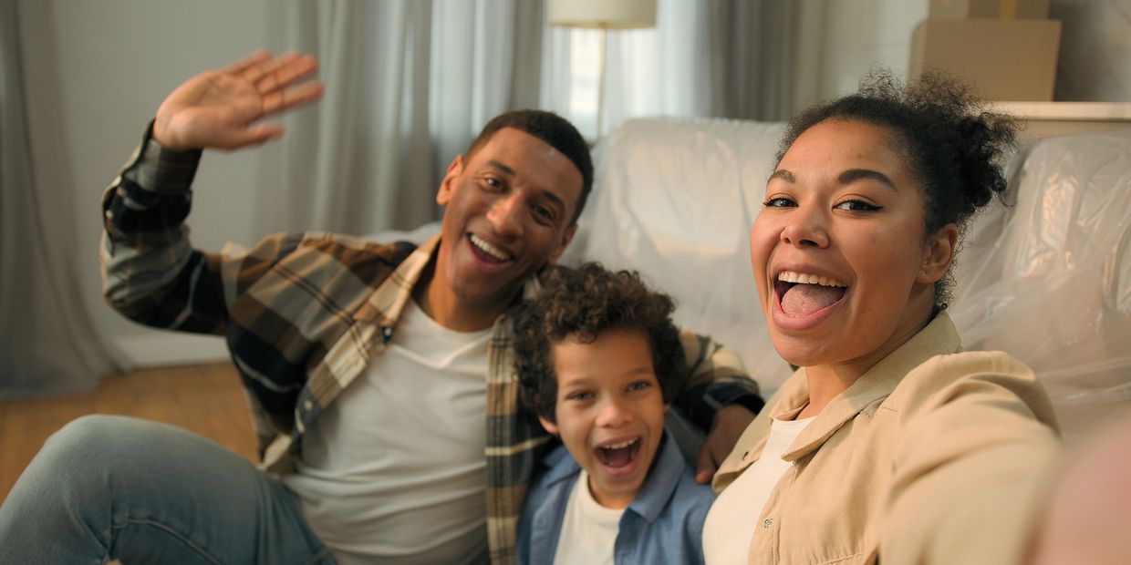 Happy family taking a cheerful selfie together at home.