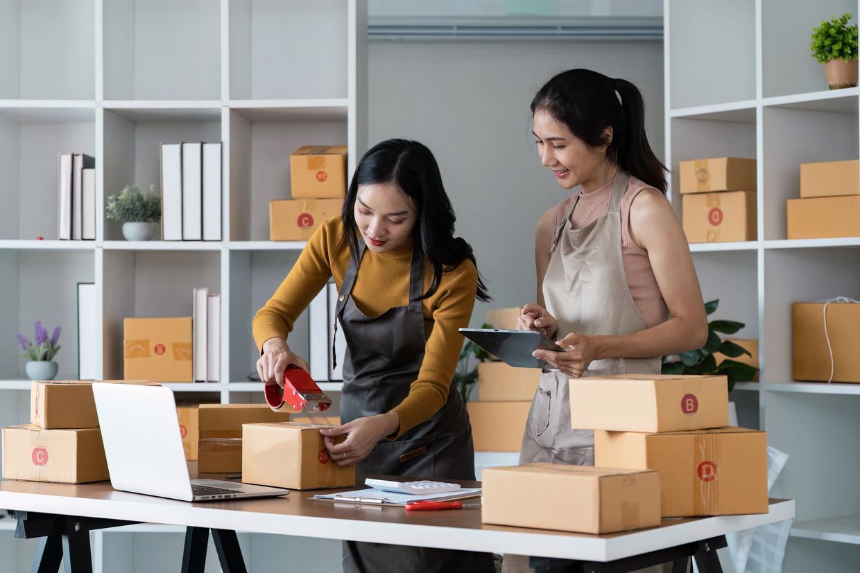 Women shipping packages for dropshipping business.