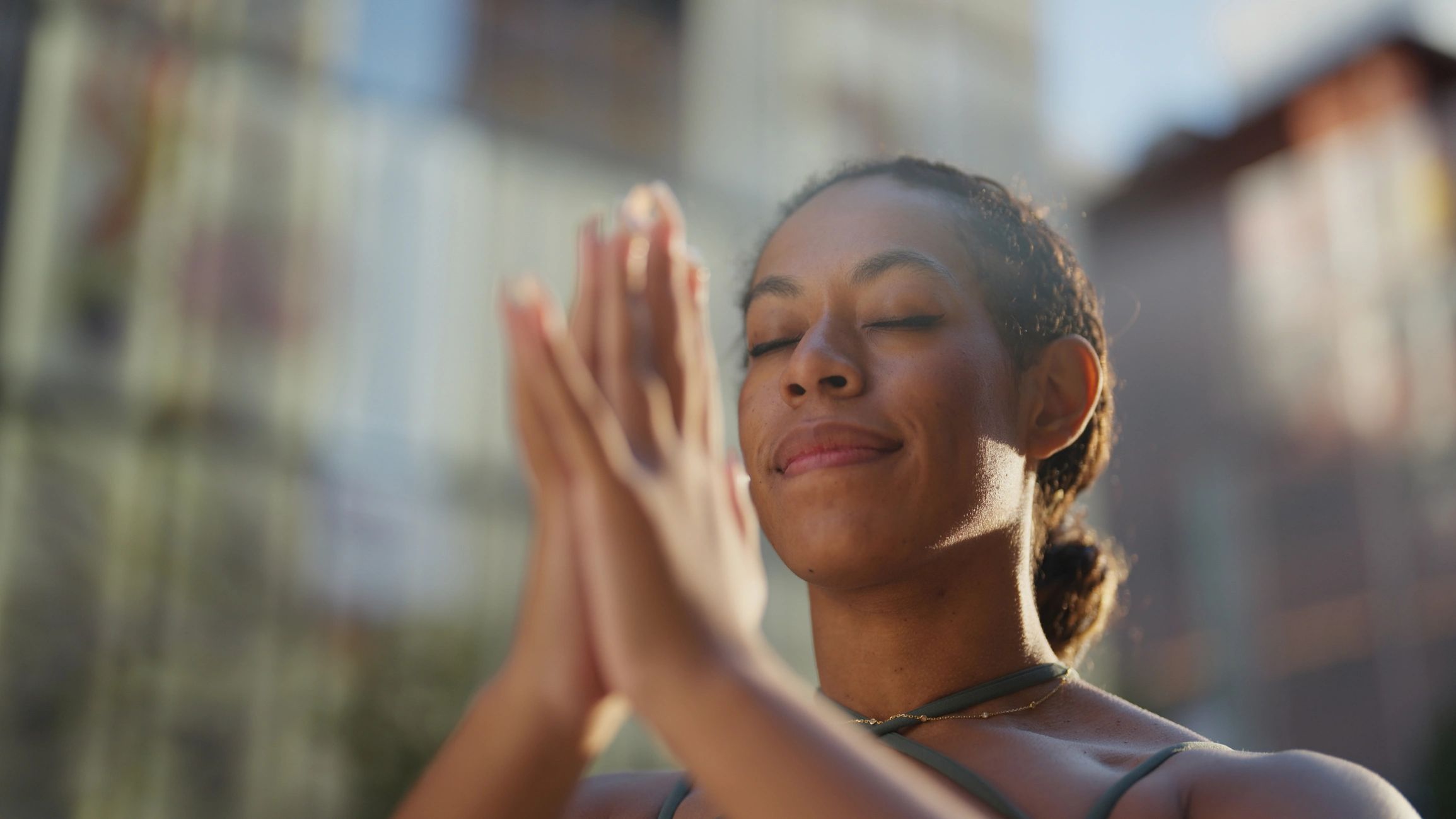 Stack of books next to pencils in a holder and a camera.