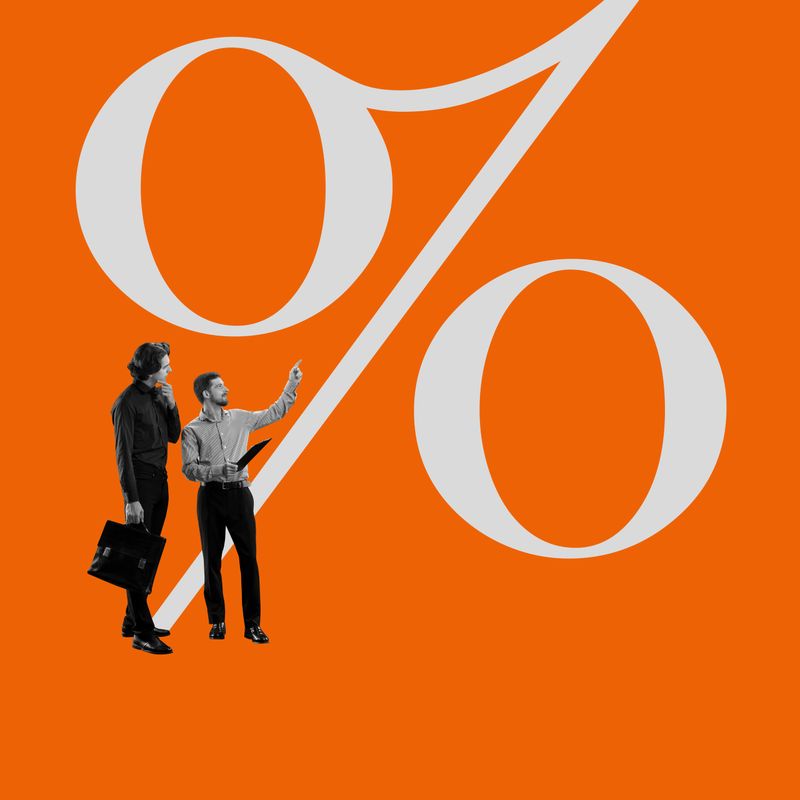 Two businessmen standing next to large percentage sign, engaged in serious discussion, Evaluating performance metrics, analyzing revenue. Concept of business, ROI, profit, financial strategy