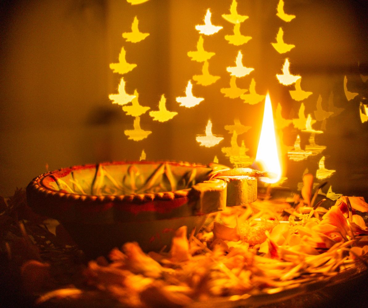 Traditional clay diya lamp with marigold flowers for authentic Vedic puja and jaap services