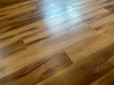 Smooth wooden floor with natural grain patterns and a warm finish.