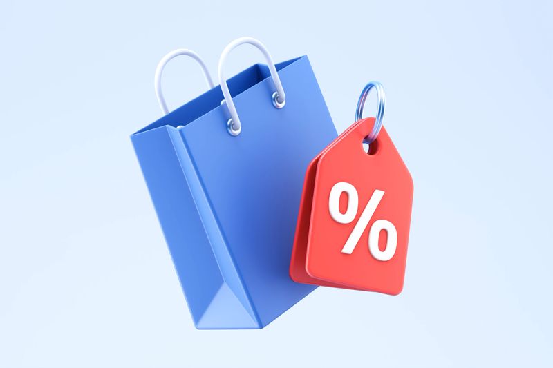 A 3D illustration featuring a blue shopping bag with a red discount tag