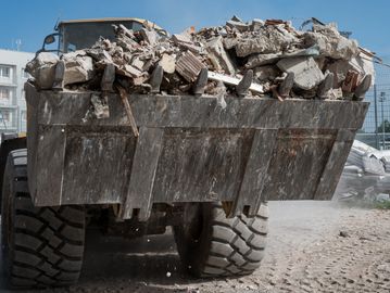 Construction site debris being efficiently cleared by a loader