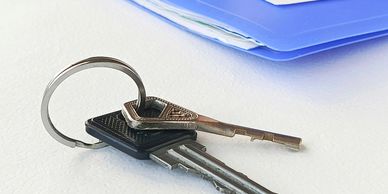 A set of keys with a blue folder in the background.