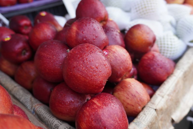 Water drops are visible on the fresh apples