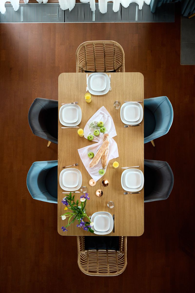 An elegantly designed dining table that is beautifully arranged with fresh flowers and exquisite tableware
