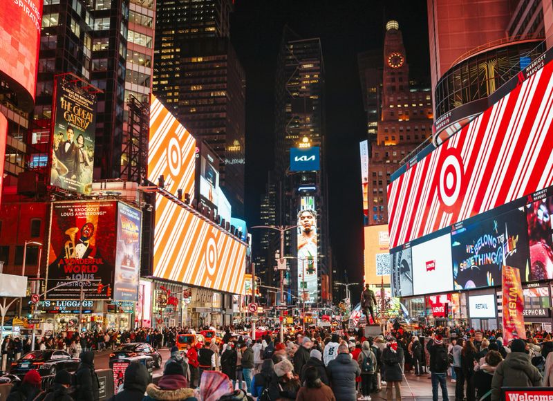 illuminated billboards and screens at crowded times square in manhattan - new york at night