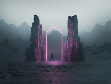 A person stands before a glowing pink arch between two towering rocks in a misty mountainous landscape.