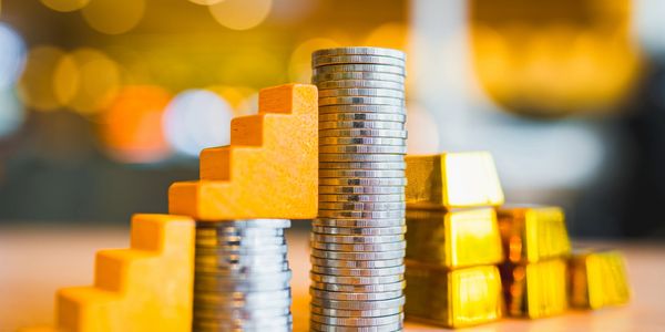 nice image of stacked coins depicting the concept of investing in your home to save on energy costs