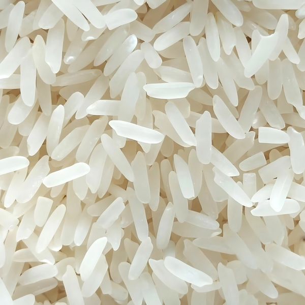 Close-up of uncooked white rice grains densely packed together.