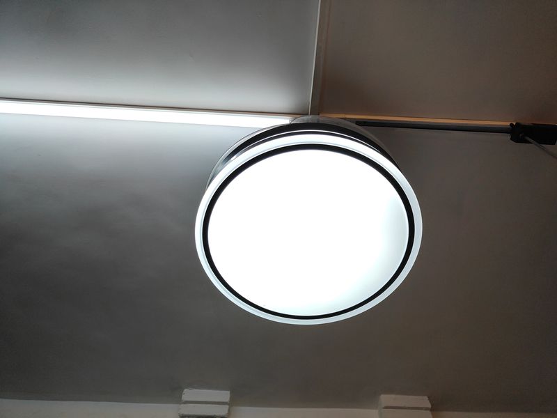 A white light fixture hangs from the ceiling. The light is on and the room is bright