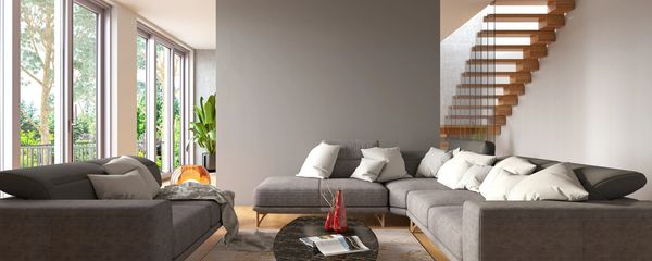 Painter and decorator looing at a painted blue wall