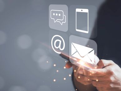 Person using smartphone with digital email and message icons.