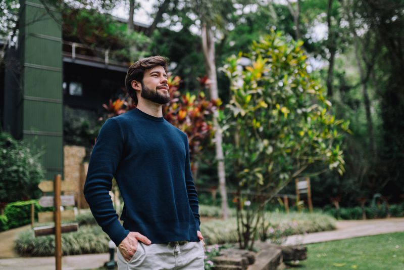Portrait of a beautiful man standing outdoors in a garden
