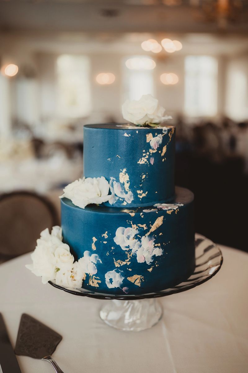 Wedding reception dessert cake with gold leafing and white decorations