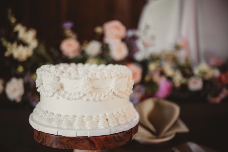 Close up of all white wedding cake with buttercream frosting