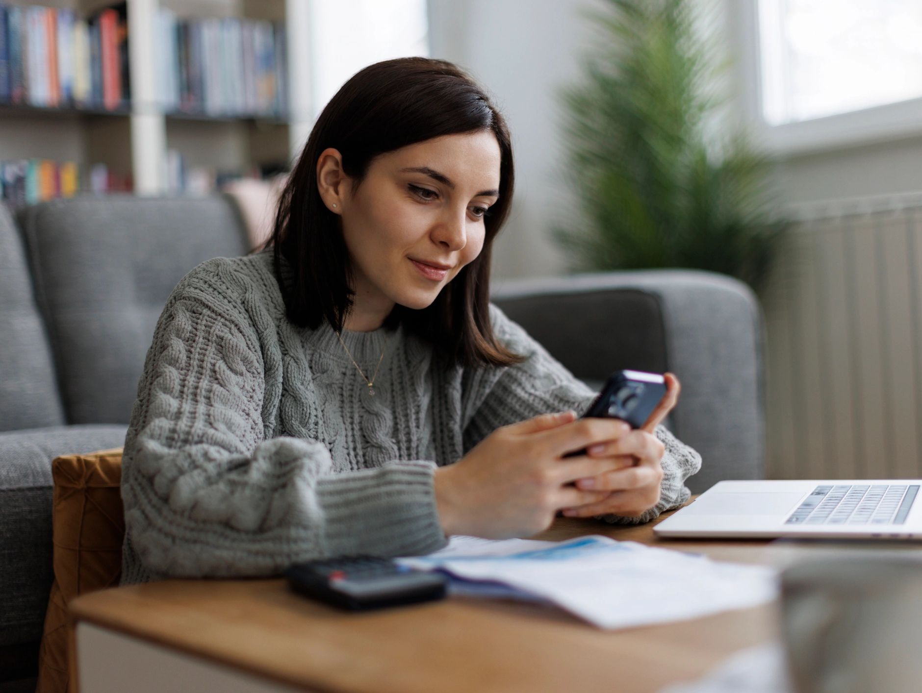 Woman using a smartphone at home.