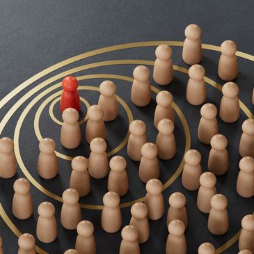 Red figure stands out among many beige figures on concentric circles.