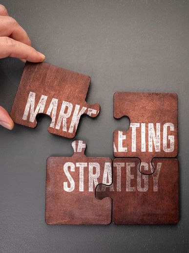 Puzzle pieces forming 'Marketing Strategy'.