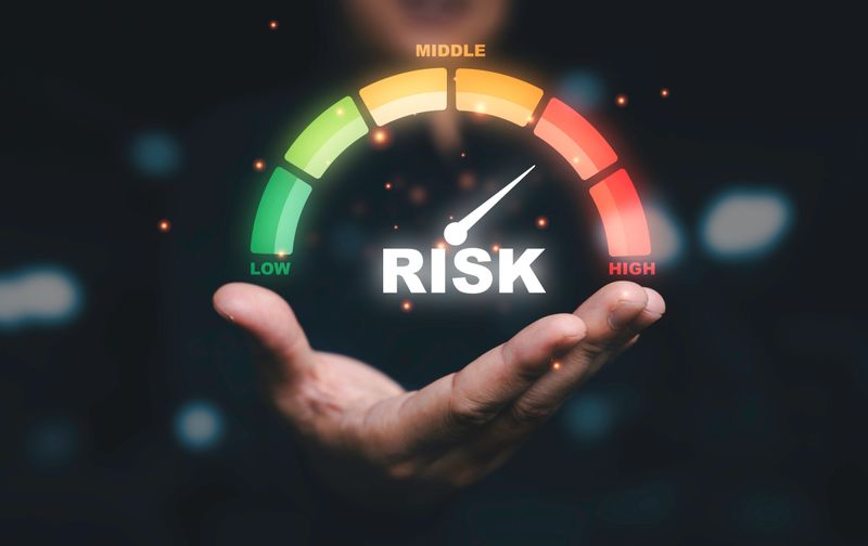 Businessman holding risk level indicator rating since low to high for Risk management and assessment