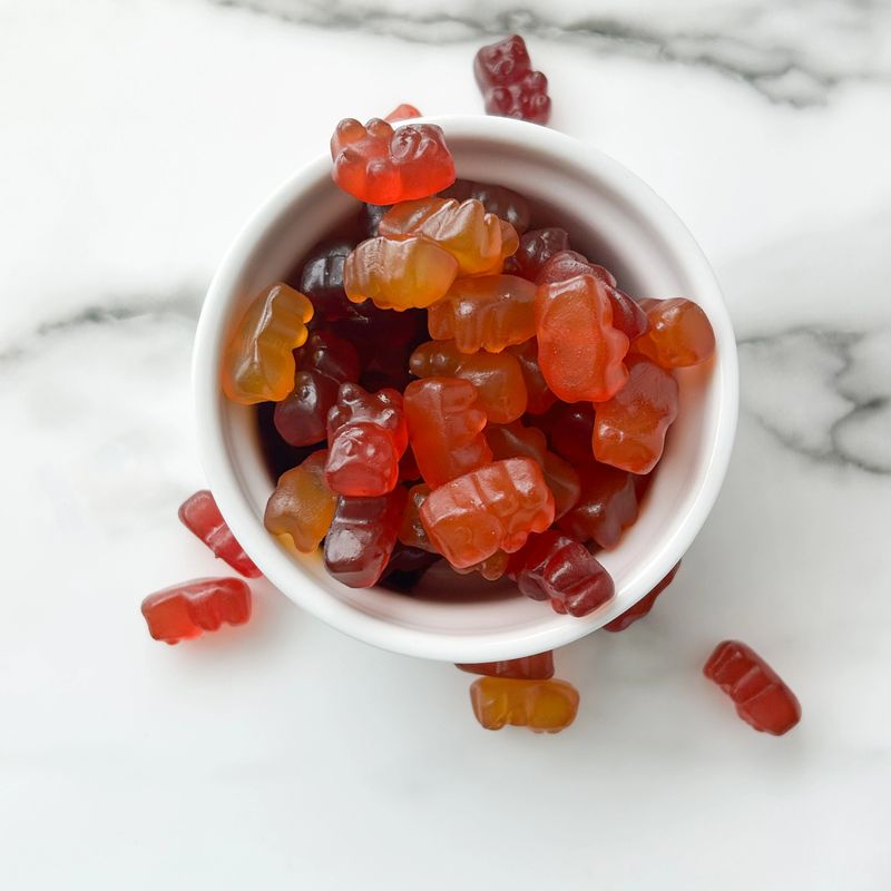 Flat Lay Of Vitamin Gummies On A White Background