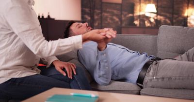 Man lying on a couch during a therapy session.