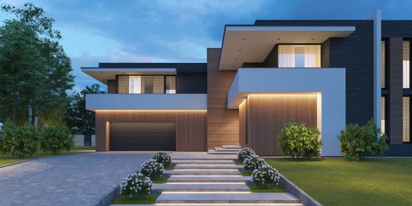 Modern house with illuminated stairs and warm exterior lighting at dusk.