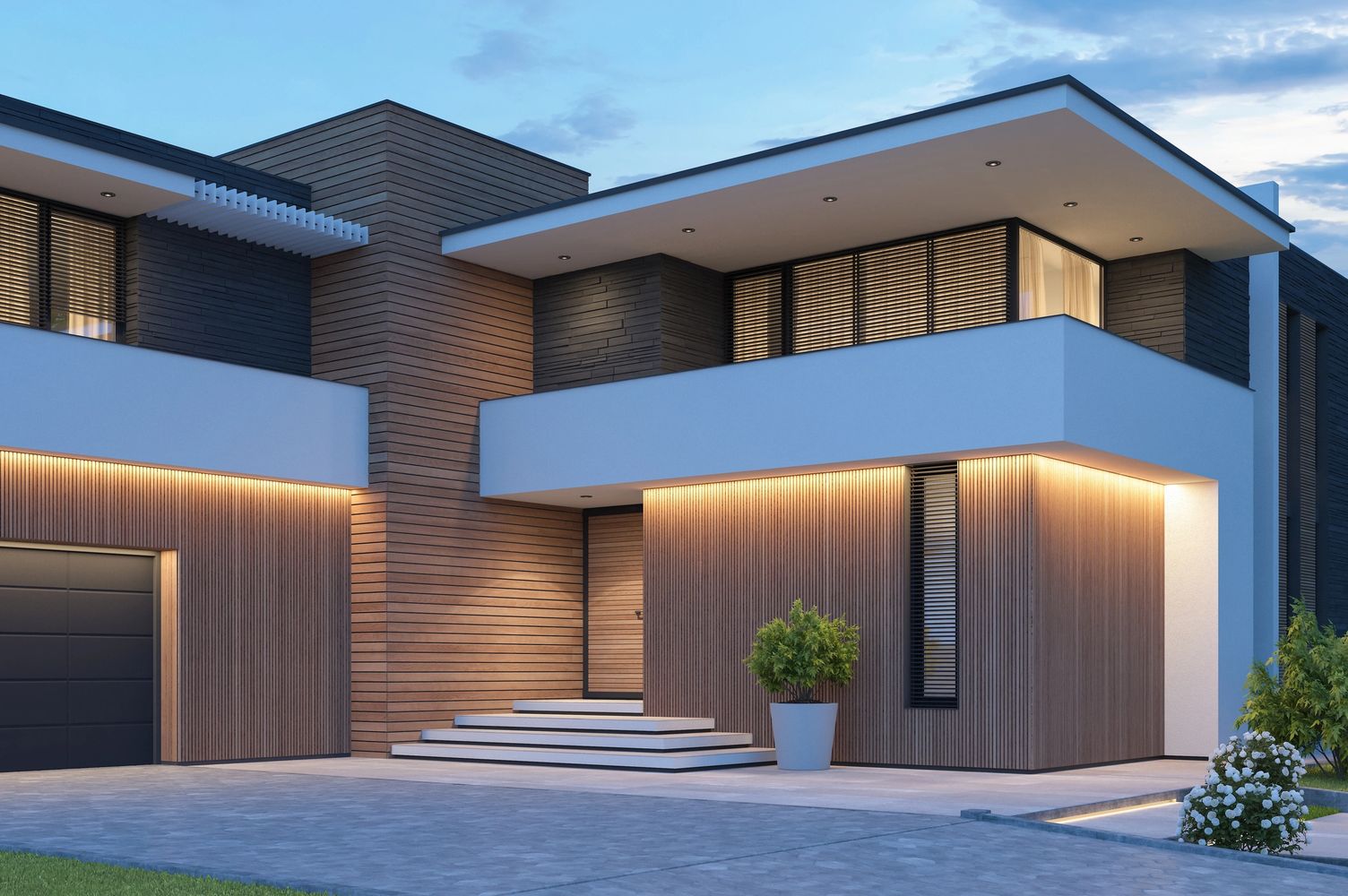 Modern two-story house with wood paneling and warm exterior lighting at dusk.