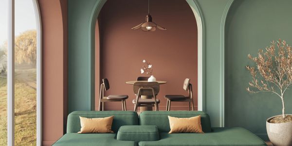 Modern living room with green sofa and dining area.